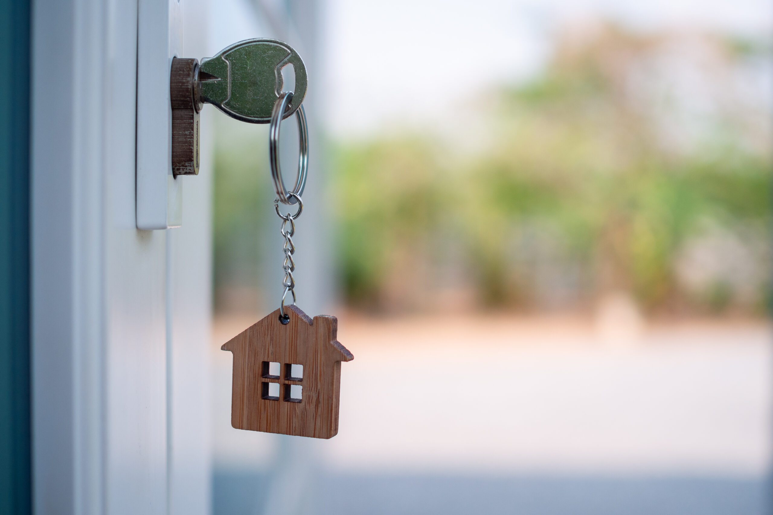 picture of a home door open with the key inside the lock